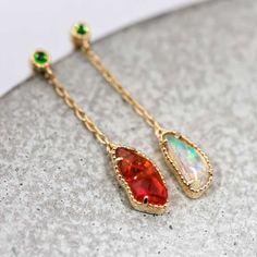 Fantastic Australian Opal Jewelry Two Colors Mexican Fire Opal Tsavorite Drop Earrings 18k Yellow Gold.  Free Domestic USPS First Class Shipping! Free Gift Bag/Box with every order! Every Opal piece is Unique. We only use high quality Natural Australian Opals ( NO synthetics or imitations). Quality is our commitment. Please do not hesitate to contact me if you have any questions or concerns:) *All pictures were taking under the natural light. ABOUT THIS PRODUCT Solid 18k Yellow Gold Mexican Fire Gold Opal Drop Earrings, Yellow Gold Opal Teardrop Pendant Jewelry, Yellow Gold Opal Earrings For Gifts, Mexican Fire Opal Jewelry, Opal Promise Ring, Promise Bracelet, Australian Opal Jewelry, Rainbow Style, Opal Birthstone