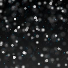 snow flakes on a black background with white and blue dots in the middle,