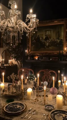 a dining room table is set with candles and plates