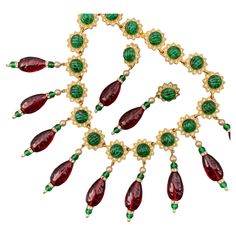 Fit for Queen is Signed Kenneth Lane Statement necklace and matching clip-on earrings featuring linked gold plated flowers with clear crystals and ribbed emerald green glass cabs center . Front flowers have ruby colored resin dangles , Necklace and earrings are signed Kenneth © Lane on backside . Matching earrings are 2.75 inches x 3/4 inches max width Statement Bib Necklace, Kenneth Jay Lane, Flower Plates, Bib Necklace, Emerald Green, Clear Crystal, Green Glass, Matching Earrings, Clip On Earrings