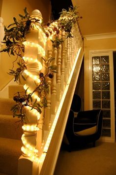 stairs decorated with christmas lights and greenery