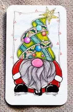 a christmas card with a drawing of a santa clause holding a tree on it's head