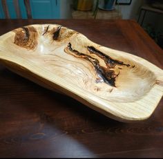 a wooden bowl sitting on top of a table