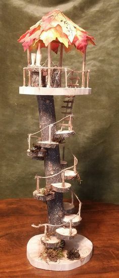 a miniature tree house with an umbrella on top