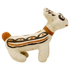 a ceramic dog figurine is shown against a white background with an orange and black design on it