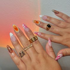 These nails feature a vibrant mix of designs, including a striking orange gradient with white tips, delicate pink and white floral patterns, and bold black tiger stripes on a neutral base. 🌸Click on the image to shop our full collection of Korean Gel Polish Gift Sets! 🌸Credit: nailsxanalysse on Instagram🌸french tips, aura nails, summer nails, autumn nails, nail inspo, tiger print nails, animal print nails, floral nails Aura And French Tip Nails, Colorful Animal Print Nails, Aura French Tip Nails, Colorful Nails Acrylic, 70s Nails Retro, Tiger Print Nails, Tiger Stripe Nails, Korean Gel Polish, Natrual Nails