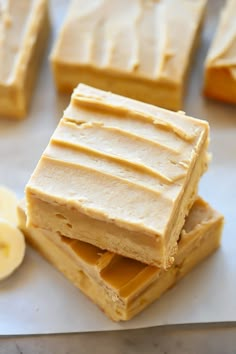 several pieces of cake sitting on top of each other next to slices of banana and peanut butter