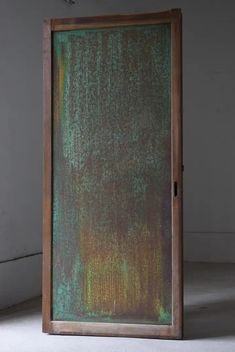 an open door with green and brown paint on it