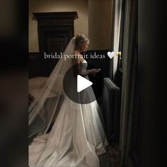 a woman in a wedding dress looking out the window