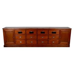 a large wooden dresser sitting on top of a white wall