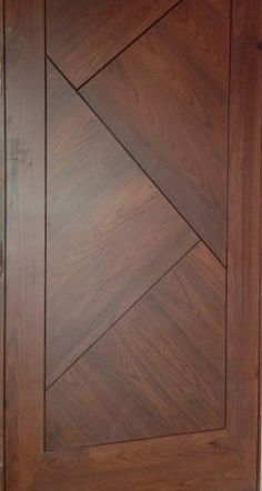 a close up of a wooden door with diamond design