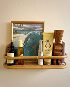 a shelf with various items on it and a painting in the corner behind it,