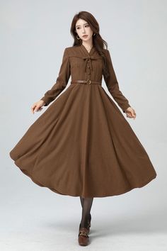 About this item: This long brown wool dress has bow and button decoration. The attention to detail in the construction of this women brown long wool dress is evident in every stitch,  show casing the craftsmanship and expertise that went into its creation.  This made-to-measure brown wool dress，crafted with an eye for detail and a commitment to excellence. DETAIL * 30% wool, 30% fiber, 40% polyester * Fully satiny lining, more nice to the touch body * Two side seam pockets      * Back zipper closure        * Long wool dress * Fit and flare dress * V neckline  * Long sleeves * Brown wool dress * Formal dress * Perfect for autumn and winter * Dry clean * Belt not for sale * Learn More about the items From the FAQs on the page bottom MODEL SIZE Bust 85 cm(33.4") Waist 67 cm(26.7") Height 168c Winter A-line Midi Dress With Buttons, Fall A-line Midi Dress With Buttons, Brown Long Sleeve Dress With Buttons, Vintage A-line Midi Dress For Winter, Vintage Brown Midi Dress For Fall, Fall Knee-length Dresses With Bow, Brown Long Sleeve Midi Dress With Buttons, Brown Knee-length Midi Dress For Winter, Fall Vintage Long Sleeve Dress With Buttons