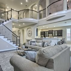 a living room filled with furniture and a spiral staircase