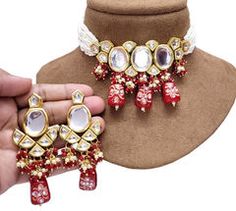 Gold Rodium Polish Red and Maroon color Necklace in Metal Alloy studded with Kundan Red Jeweled Temple Jewelry, Red Bridal Necklace For Party, Red Jewelry For Festival Party, Red Jeweled Jewelry For Celebration, Red Metal Jewelry Sets For Party, Red Kundan Necklace For Festivals, Red Kundan Pendant Necklace For Festivals, Red Pendant Kundan Necklace For Festivals, Red Jewelry Sets For Festivals