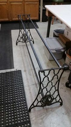 two metal railings sitting next to each other on top of a tile floor in a kitchen