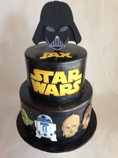 a three tiered cake decorated with star wars characters