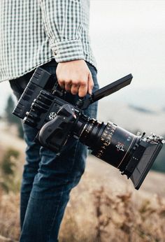 a man holding a camera in his hand