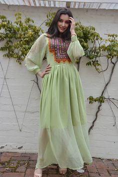 Vintage Afghan dress with a touch of modern style. Green A-line Gown For Spring, Fitted Chic Dress For Festive Occasions, Fitted Festive Chic Dress, Green Long Casual Dress, Festive Long Sleeve Dresses With Sheer Sleeves, Festive Chic Maxi Length Dresses, Festive Chic Maxi Dresses, Spring Dresses With Sheer Sleeves And Flowy Fit, Spring Flowy Dress With Sheer Sleeves