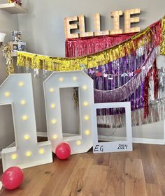 the letters are made out of white wood and have lights on them, along with decorations