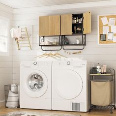 a washer and dryer sitting in a room next to a shelf with pictures on it