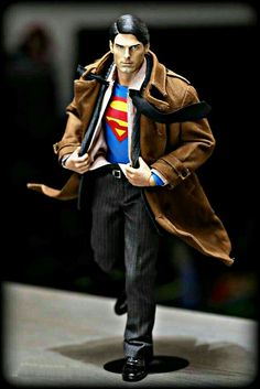 the action figure is wearing a brown coat and tie