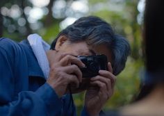 an older man taking a photo with his camera