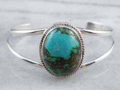 The quality of workmanship in this vintage cuff is simply gorgeous, with an even balance between the silver bands and the glowing, incredible turquoise cabochon at the center. We've given it a light polish but otherwise left it untouched. Metal: Sterling Silver Gem: Turquoise Gem Measurements: 26.7 x 19.6 mm, Oval Width: 30.9 mm Inside Diameter: 5 Inches Marks: "STER" Stamped Turquoise Silver Bracelet, Cabochon Bracelet, Turquoise Gem, Silver Bands, White Pearl Earring, Sparkly Things, Pearl And Diamond Earrings, Turquoise Bracelet Cuff, 925 Silver Bracelet