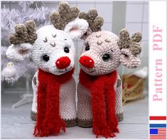 two knitted reindeers are standing next to each other