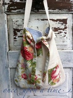 a purse hanging on the side of an old door with a ribbon attached to it