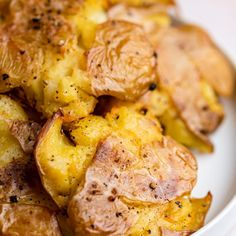 a white plate topped with potatoes covered in seasoning