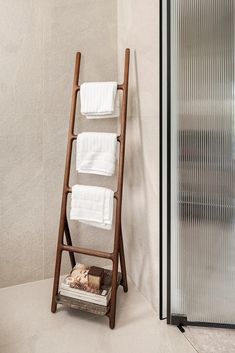 a towel rack in the corner of a bathroom