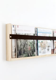 a wall mounted shelf with magazines on it