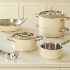 pots and pans sitting on top of a white counter