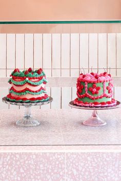 three cakes sitting on top of a table next to each other