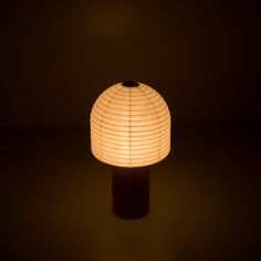 A portable Yame lantern with a wooden handle and bell-shaped cylindrical paper top emitting warm light in a dark room Paper Table Lamp, Japanese Lighting, Bell Paper, Japandi Home Decor, Japanese Lamps, Japanese Table, Japanese Washi Paper, Dining Table Living Room, Traditional Lanterns