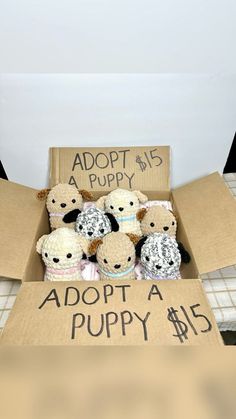 a box filled with stuffed animals sitting on top of a bed