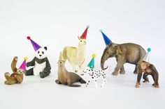 several toy animals with party hats on their heads