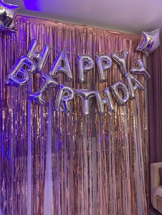 a birthday party with balloons and streamers in the shape of letters that spell happy birthday