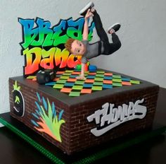 a cake with a man doing a trick on top of it