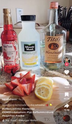 the ingredients to make strawberry lemonade are displayed on a cutting board, along with two bottles of vodka