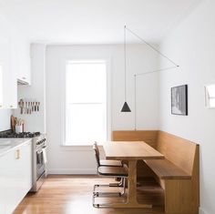 a kitchen with white walls and wooden floors