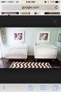 two baby cribs in a room with pictures on the wall and carpeted floor