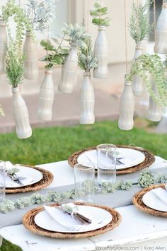 an outdoor table set with plates and place settings