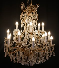 a chandelier with many candles lit up