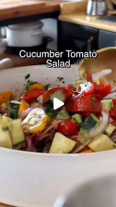 a white bowl filled with vegetables on top of a wooden table