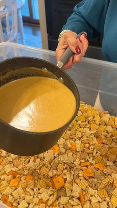 a person is mixing some kind of food in a bowl on top of corn flakes