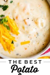 the best potato soup recipe with cheese and parsley in a white bowl on a colorful napkin