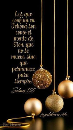 three christmas ornaments hanging from strings with the bible verse written in spanish above them on a black background