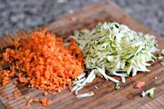 chopped carrots and shredded cabbage on a cutting board